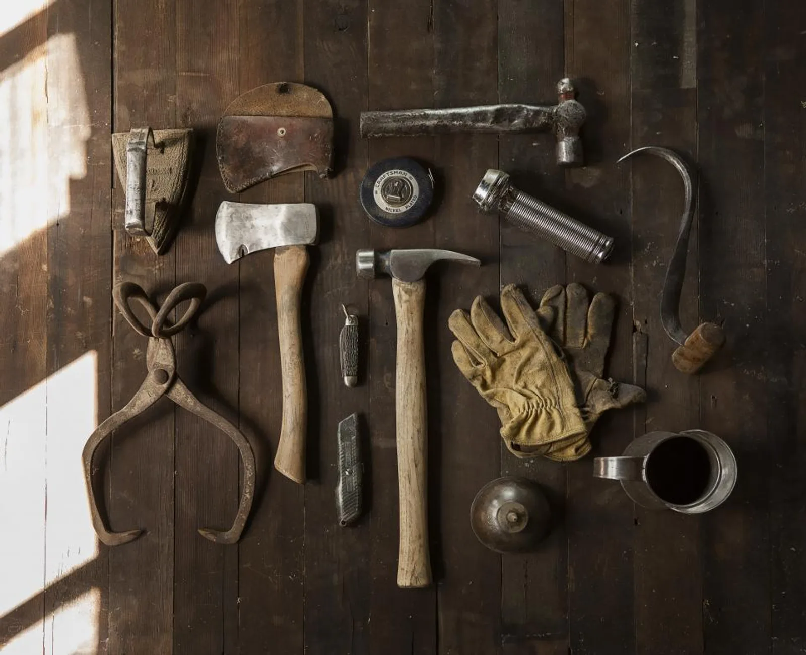 Hand tools laid out on a wooden workbench