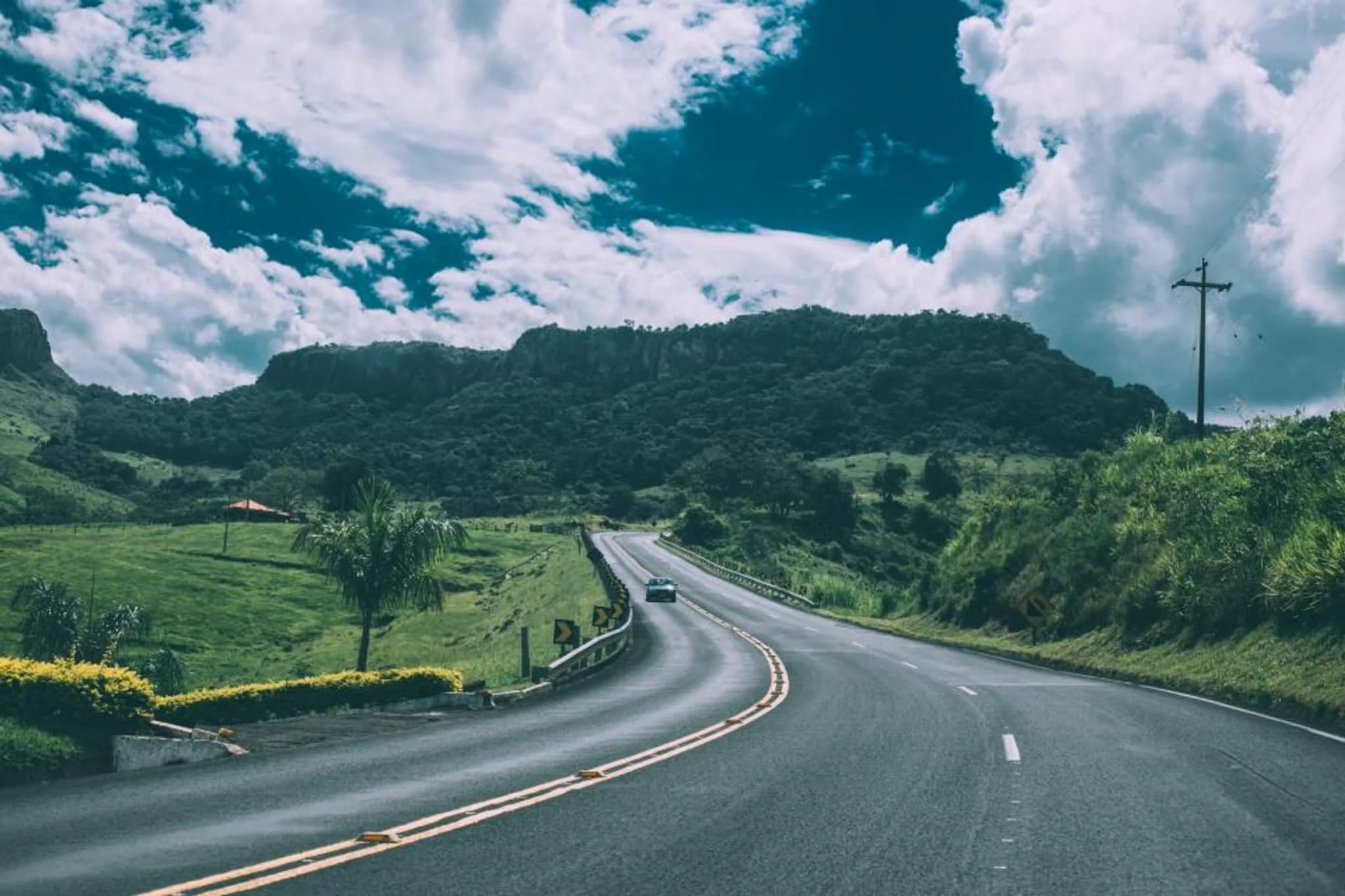 A highway winding through green hills